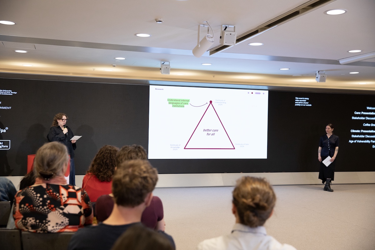 Audience observing a presentation show that has a triangle figure